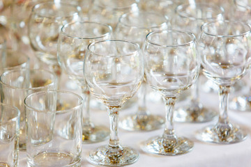 Empty wine glasses standing in row on table