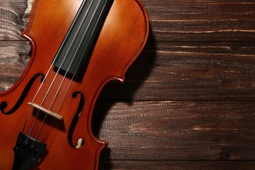 Fototapeta na wymiar Violin on brown wooden table