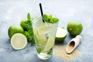 Mojito cocktail in glass on grey wooden table