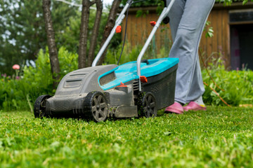 outdoor worker mowing the lawn