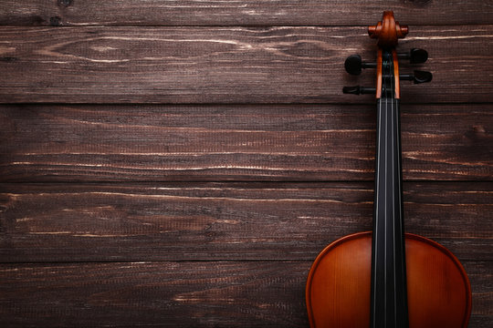 Violin on brown wooden table