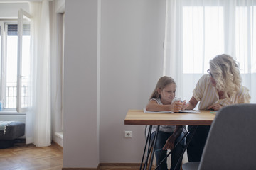 Fototapeta premium Schoolgirl Learning to Write