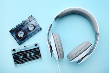 Headphones and cassette tapes on blue background