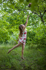 pretty young woman jumping on green park