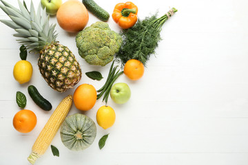 Ripe fruits and vegetables on white wooden table