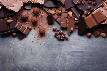 Chocolate pieces with nuts on grey wooden table