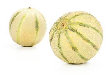Group of two whole fresh melon cantaloupe variety front in focus isolated on white background