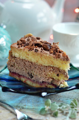 A piece of fluffy sponge cake with coffee cream on a blue plate