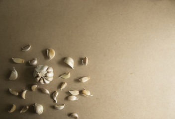 Whole Garlic and Garlic Cloves on the MDF wooden plate board Texture Background with copy space for your text