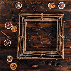 Frame with spices, dried fruit and empty space for text on wooden background