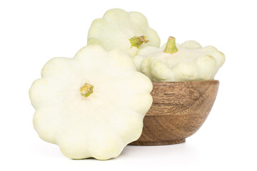 Set of three whole summer white pattypan squash with wooden bowl isolated on white background