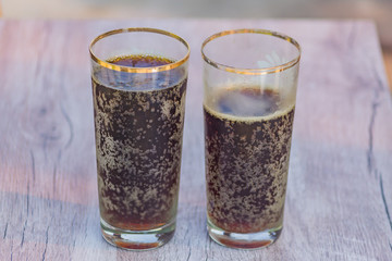 two jars of cold fresh russian kvass on wooden table outdoors