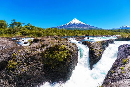 Fototapeta Salutos de Petrohue waterfalls and volcano Osorno, Puerto Varas, Chile. Copy space for text.