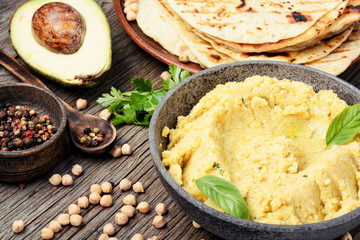 Hummus on rustic wooden table