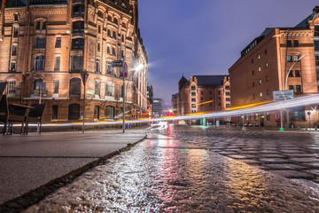Warehouse district of Hamburg (Speicherstadt) at night. Nice reflections after rain is gone. Light trails.