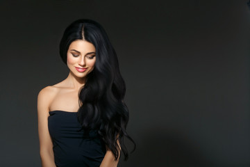 Fototapeta premium Black hair woman. Beautiful brunette hairstyle fashion portrait over dark background