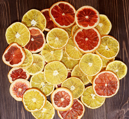 Dried oranges on a brown wooden background