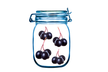 Glass jar with twigs of black berries, black currant, aronia isolated on white background. Conservation berry concept. Concept clean product.