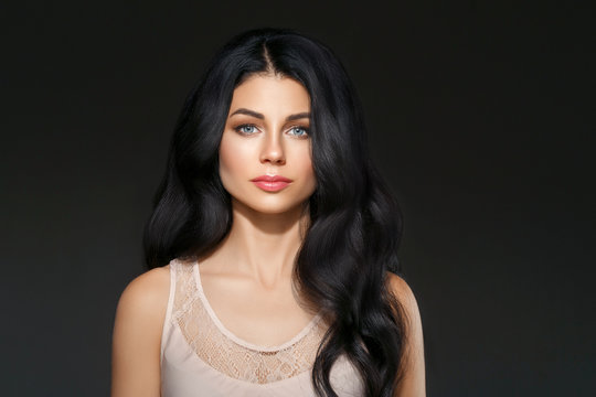 Beautiful woman face studio portrait. Beauty black long hair.