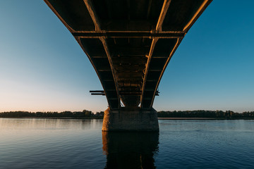 Volga bridge and embankment over Volga river at sunset, Yaroslavl region, Rybinsk city, Russia. Beautiful landscape