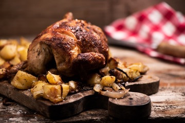roasted chicken on wooden cutting board