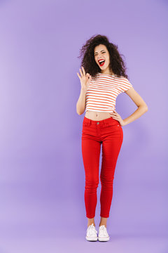 Full length portrait of a happy young casual woman posing