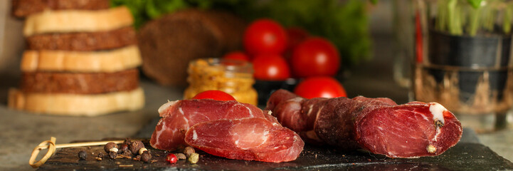 salami, salted meat jerky - sliced ​​with slices (venison) . food background.  Top view with copy space