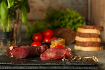 salami, salted meat jerky - sliced ​​with slices (venison) . food background.  Top view with...