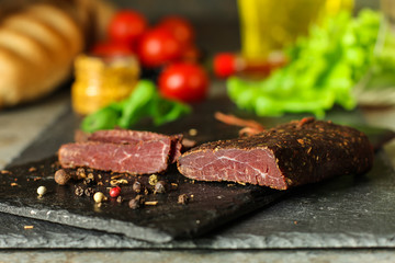 salami, salted meat jerky - sliced ​​with slices (venison) . food background.  Top view with copy space