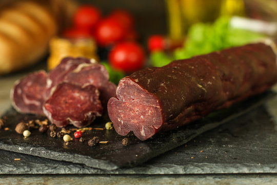 salami, salted meat jerky - sliced ​​with slices (venison) . food background.  Top view with copy space