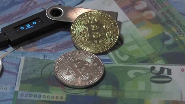 Physical metal Bitcoin currency over bolivar bills. Virtual internet money with Venezuelan banknotes. Digital coin cyberspace, cryptocurrency. BTC golden coin as symbol of electronic virtual money. 4K