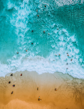 Aerial view of beach and the ocean with people 