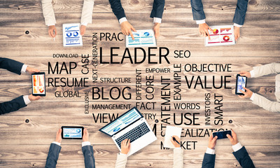 Top view of businesspeople sitting at table and using gadgets