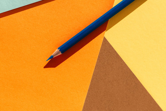  Blue pencil on geometric  background. Back to school