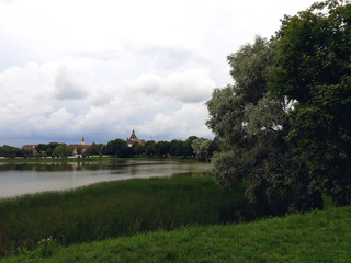 Fototapeta na wymiar NESVIZH, BELARUS - JULY 13, 2018: Lake in the park near the Nesvizh castle complex