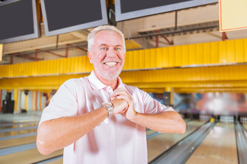 Getting ready. Joyful nice man smiling while warming up his muscles