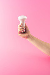 cropped shot of person holding light bulb isolated on pink