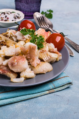 Slices of fried fish with vegetables