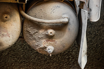 Gas cylinder in the mud attached to the car body