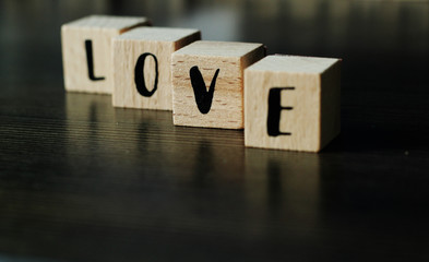 LOVE build from wooden cubes, selective focus, free copy space