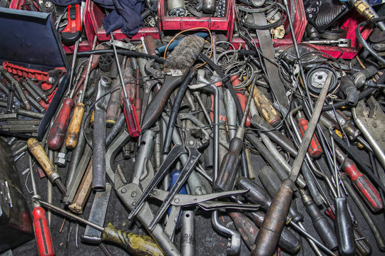 Bunch of messy hand tools in an auto mechanic garage