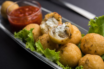 Dahi Ke Angare also known as Kabab or kebab is a popular snack item from India / Pakistan. served with green and red sauce. Selective focus
