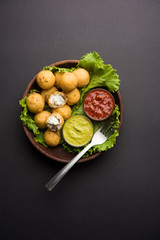 Dahi Ke Angare also known as Kabab or kebab is a popular snack item from India / Pakistan. served with green and red sauce. Selective focus
