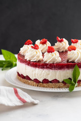Obraz na płótnie Canvas Raspberry cream mousse cake no baked cheesecake on white background. Copy space.