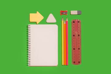 notebook, pencils, stickers, eraser and a clinch lying on a green surface. concept of secretarial...