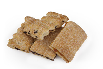 Figured shortbread cookie with strawberry jam and raisins on a white background.