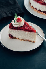 Raspberry tart, mousse cake, cheesecake with fresh raspberries. Piece of cheesecake on a white plate.