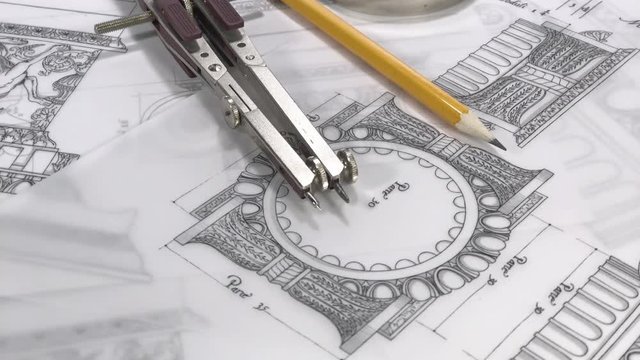 workplace of the architect: rolls of blueprints - magnifier, pencil, compasses and drawings of antique decorative elements of architectural orders / seamless looping