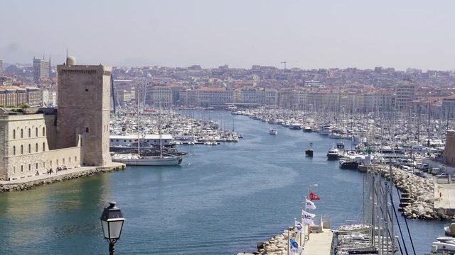 Timelapse of Vieux-Port de Marseille at harbor entrance. Famous old port in France, now marina for boats and ferries. Historic landmarks in classical European maritime town.