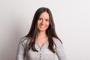 Portrait of a young beautiful woman in studio on a white background.